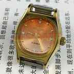 HAIDA Lady 24mm watch with gradient orange dial, gold nail markers, and 17-jewel manual movement.