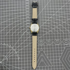 Black Dandong manual mechanical watch with 17 jewels, golden dial, single calendar for refined classic style.
