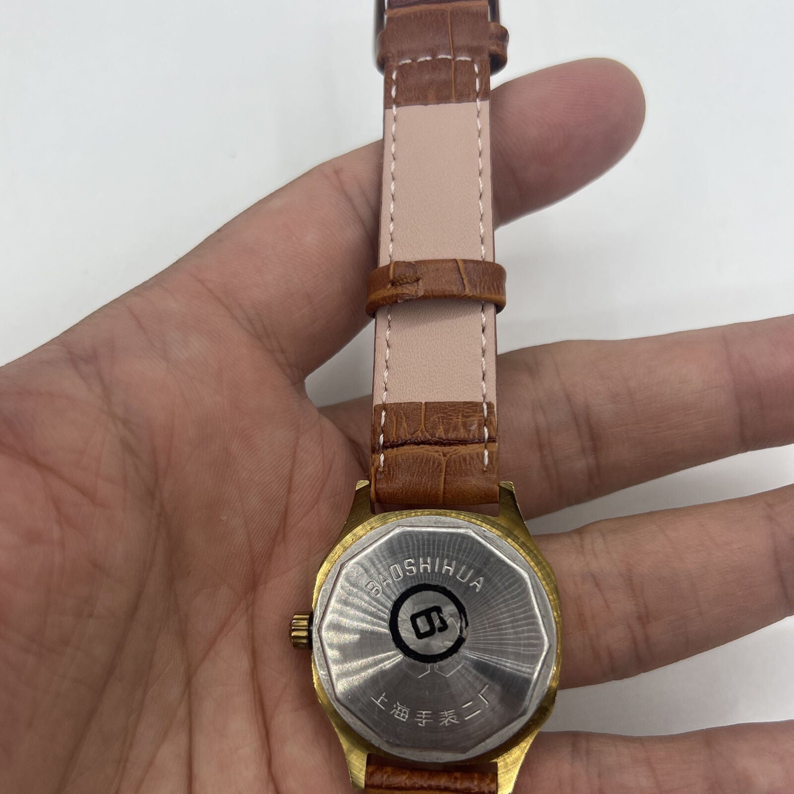32mm Shanghai manual mechanical watch with golden markers, brown dial, and octagonal case design.