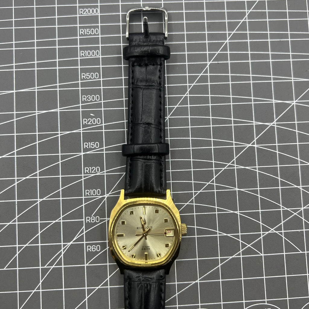 Black Dandong manual mechanical watch with 17 jewels, single calendar, and golden dial for classic elegance.