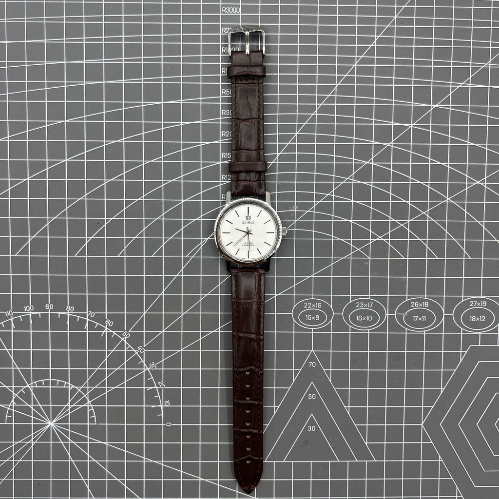 China Baihua 37mm manual mechanical watch with silver dial, 19 jewels, and shock-resistant design.