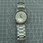 Beijing 36mm manual watch with silver case, nail-shaped markers, classic style wrist accessory.
