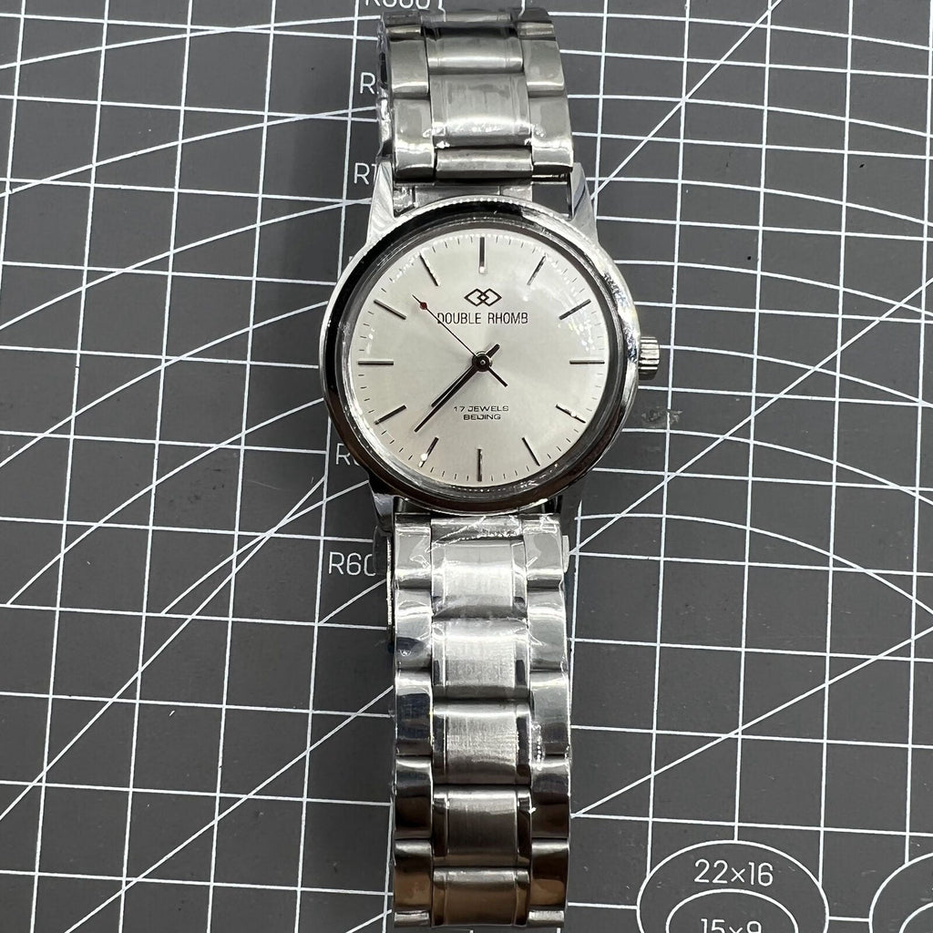 Silver 36mm Beijing Double Rhomb manual mechanical watch with silver case and nail markers, classic design by Beijing brand.