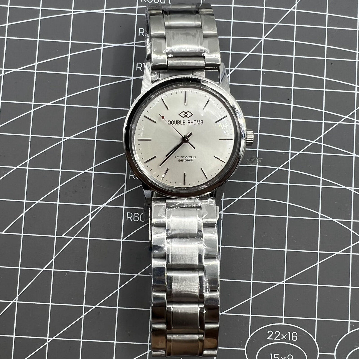 Silver 36mm Beijing Double Rhomb manual mechanical watch with silver case and nail markers, classic design by Beijing brand.