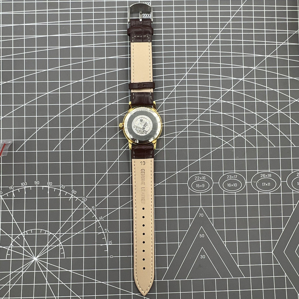 Beijing Double Rhomb mechanical watch with golden case and silver nail markers, elegant classic style for formal wear.