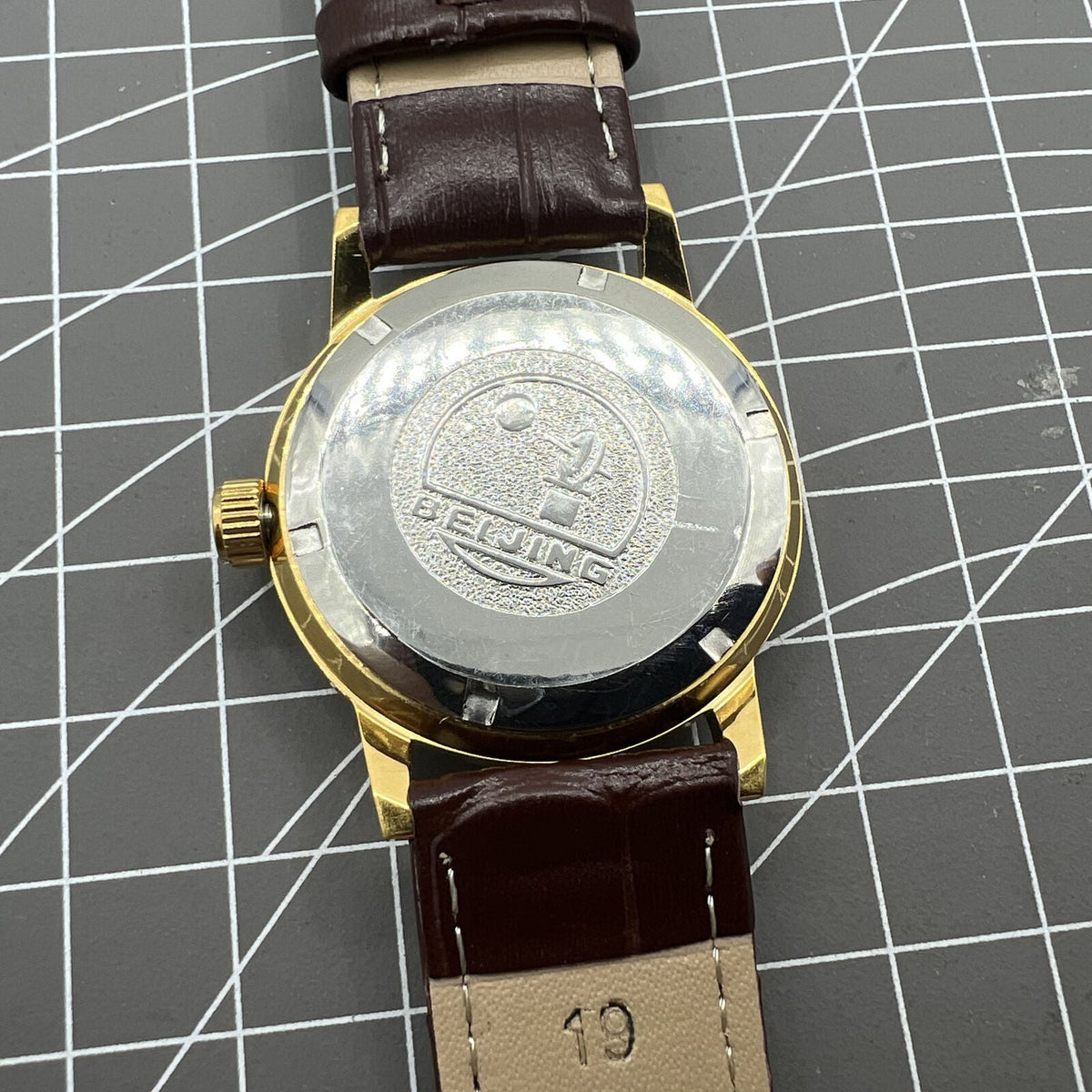 Beijing Double Rhomb mechanical watch, golden case, silver nail markers, elegant timeless design for formal wear