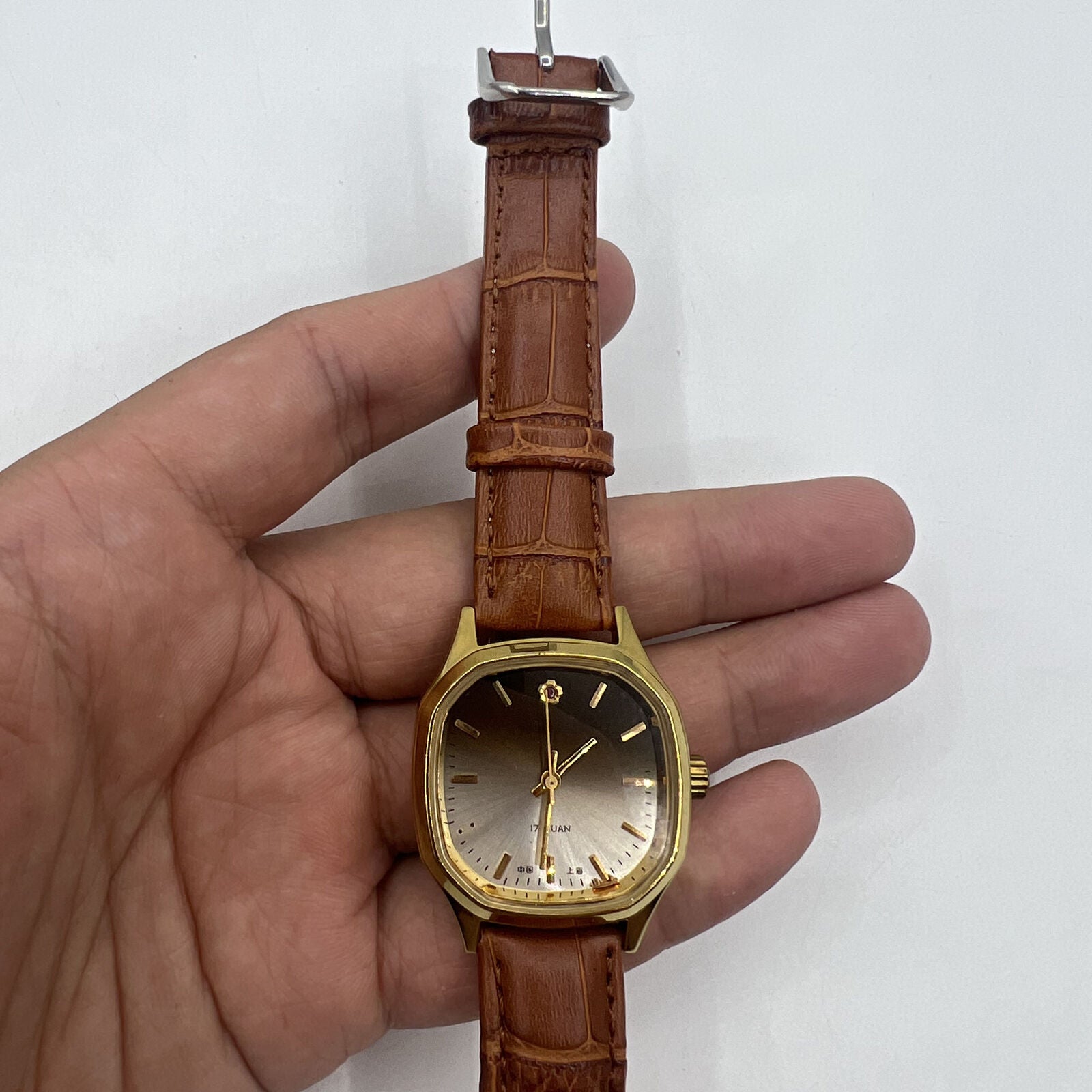 32mm Shanghai manual mechanical watch with golden indices, brown dial, and octagonal stainless steel case.