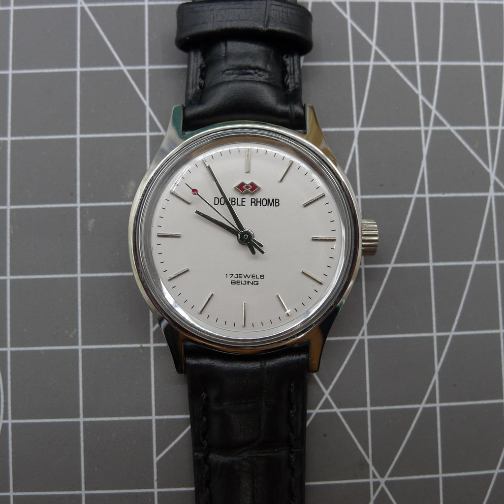 Beijing 31mm manual mechanical watch with silver case, double rhomb dial showcasing classic Chinese craftsmanship.