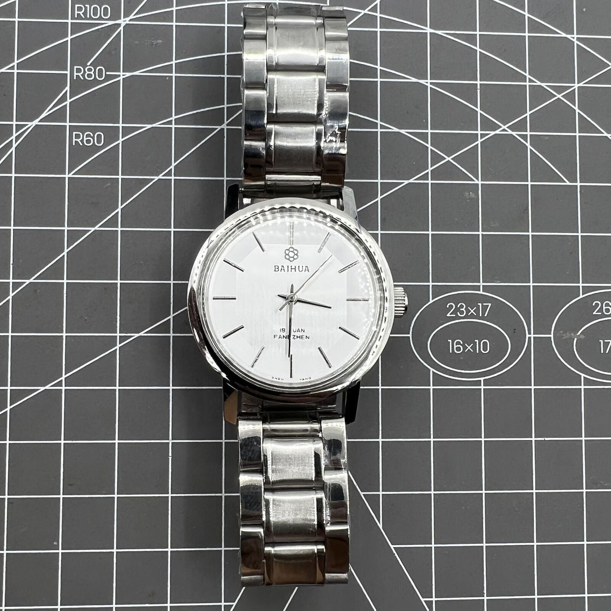37mm China Baihua manual mechanical watch with silver dial, 19 jewels, shock-resistant design for durability.