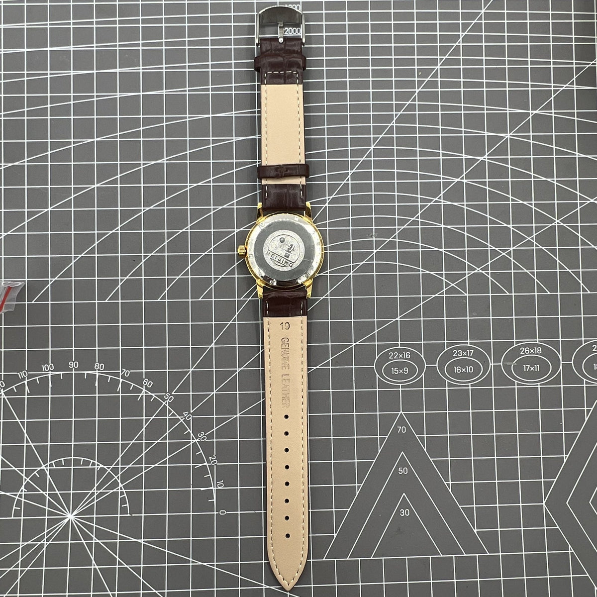 Beijing Double Rhomb manual watch, gold case with silver nail markers, classic vintage style accessory.