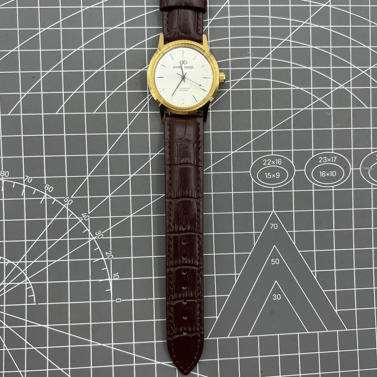 Beijing Double Rhomb manual watch featuring a golden case and silver nail markers, classic style accessory for elegant timekeeping.