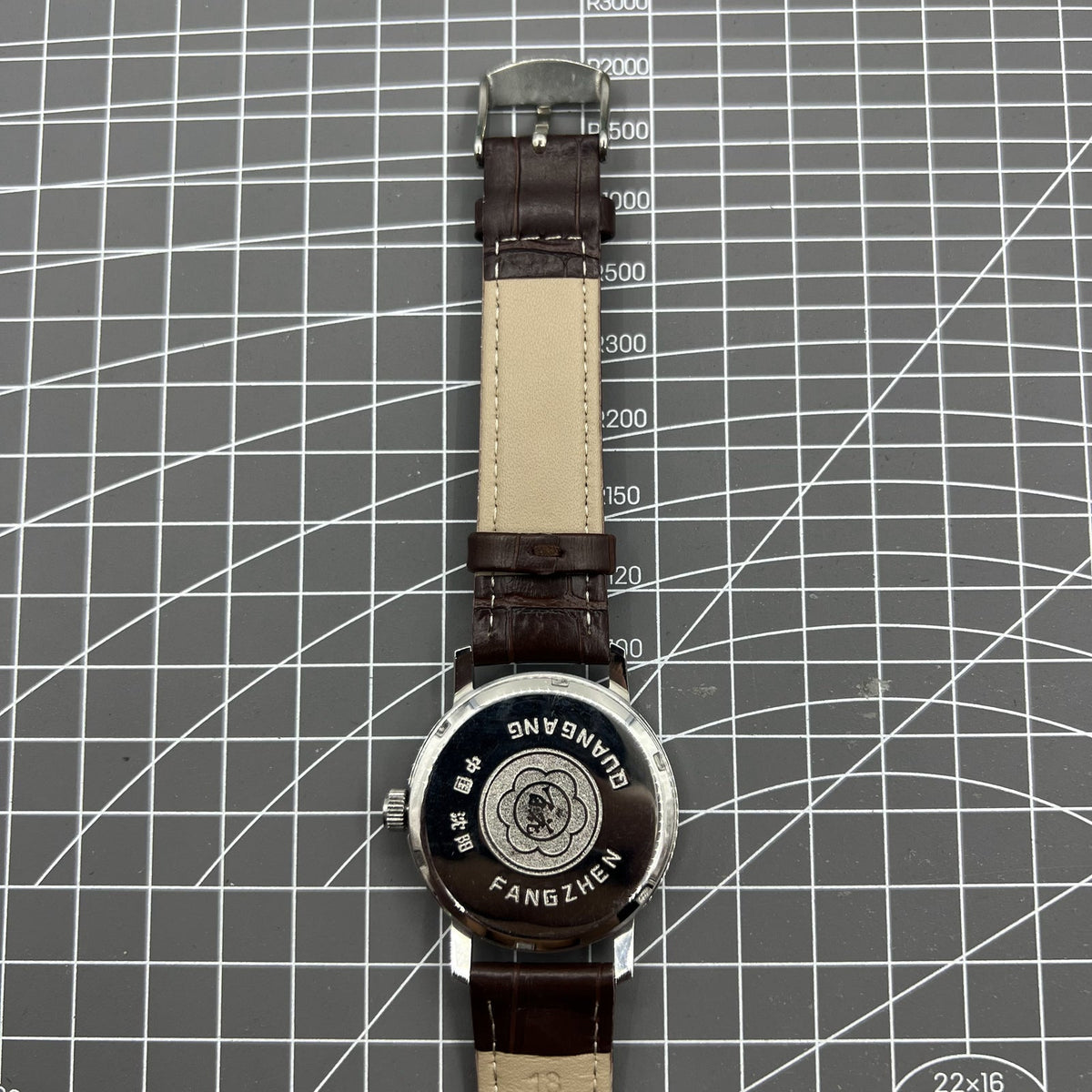 China Baihua 37mm manual mechanical watch with silver dial and 19-jewel movement, shock-resistant design for durability.