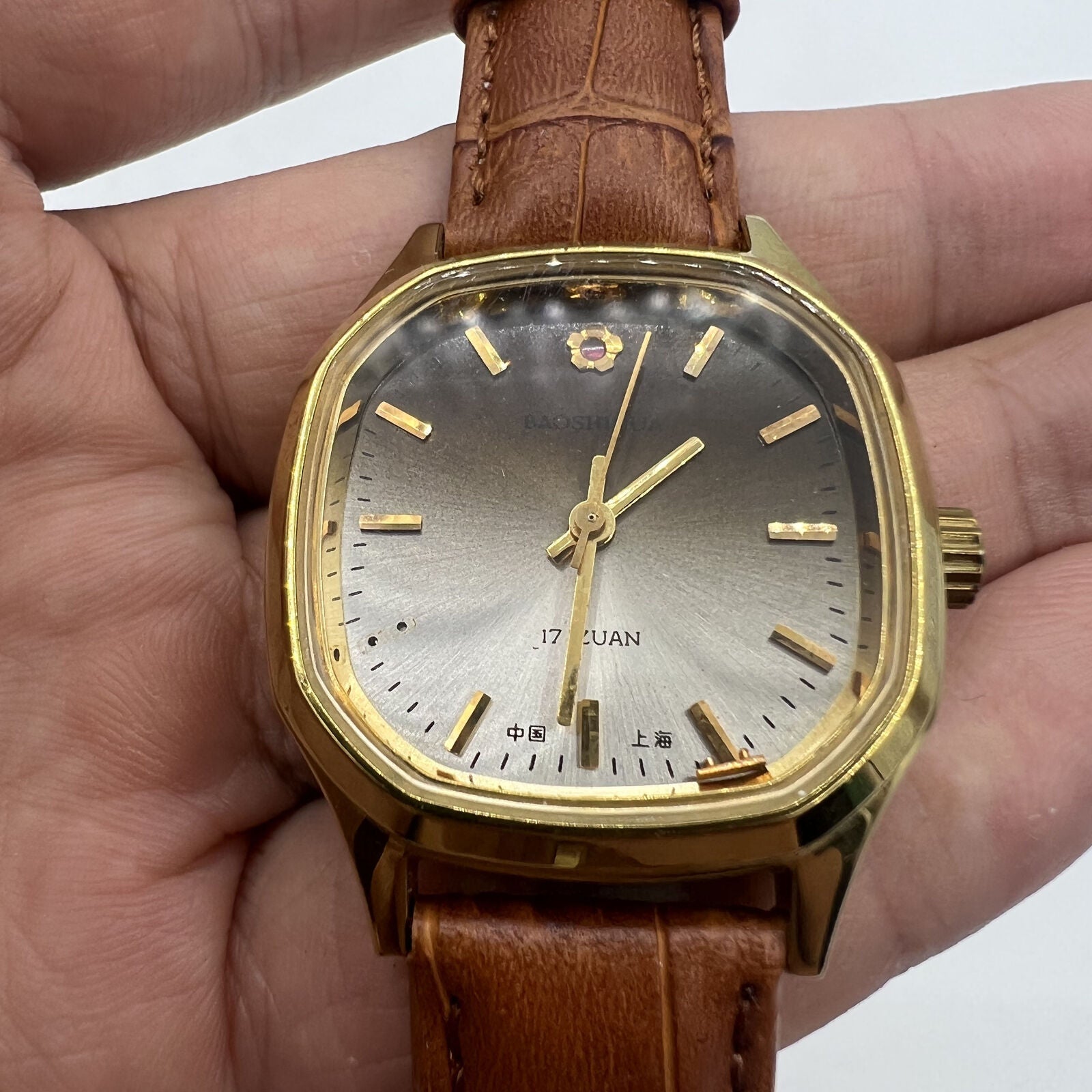 32mm Shanghai manual mechanical watch with golden markers, brown dial, and octagonal case design.