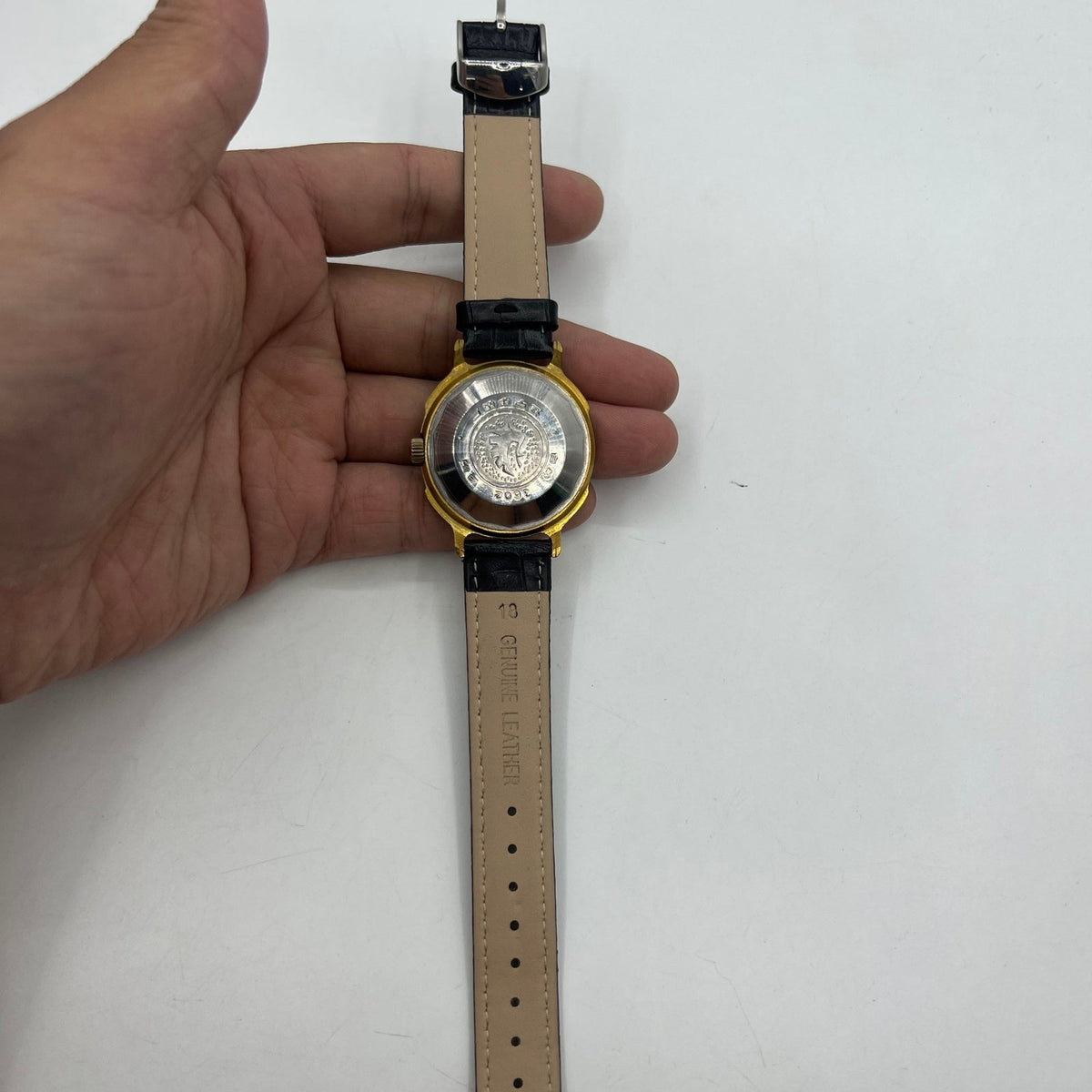 37mm automatic watch with black dial, golden Roman numerals, and 33 jewels for elegant style.