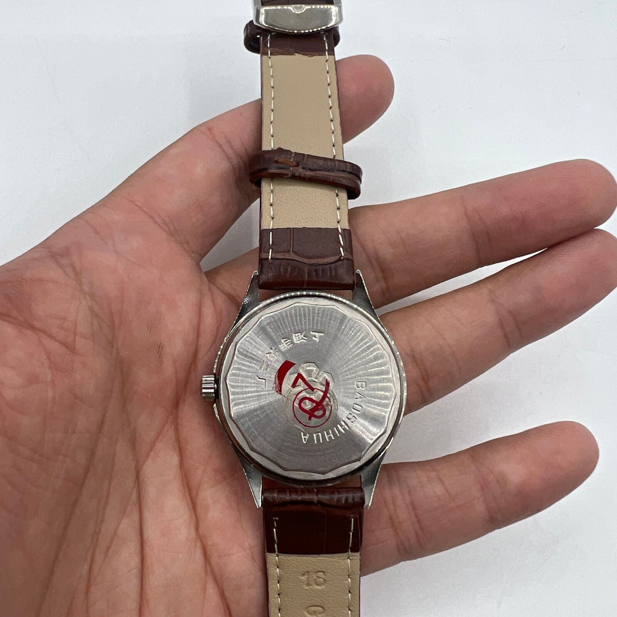 Shanghai 37mm manual watch with golden dial and nail markers, mechanical 17 jewel movement, classic round case by Shanghai.
