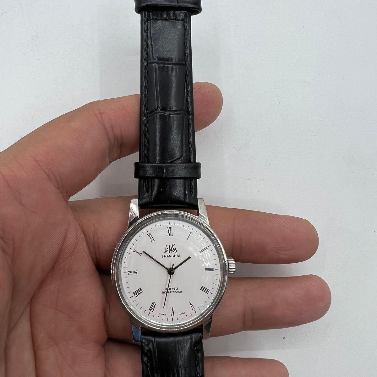 Vintage 36mm Shanghai Factory 8120 manual mechanical watch with shock-resistant 17 jewels, classic design for elegant timekeeping.