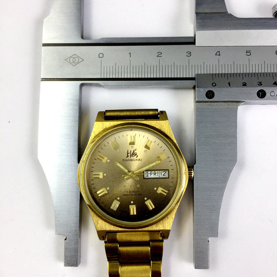 Shanghai Factory manual mechanical watch with dark brown dial featuring double calendar display.