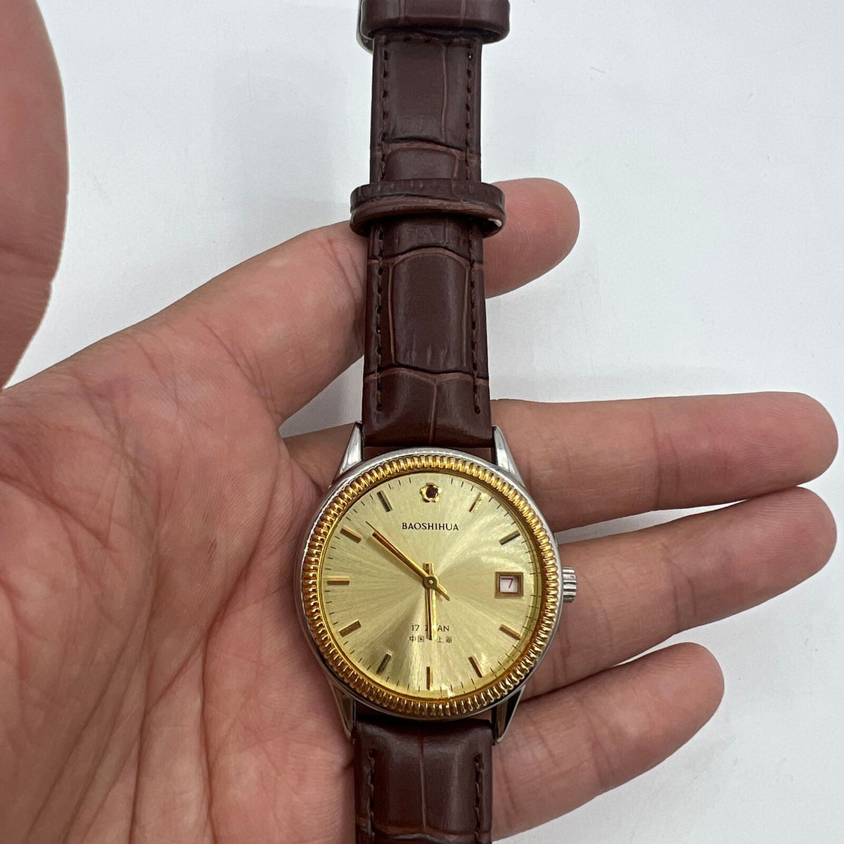 Shanghai 37mm manual watch with golden dial, nail markers, round case, 17 jewel mechanical movement for classic watch enthusiasts.