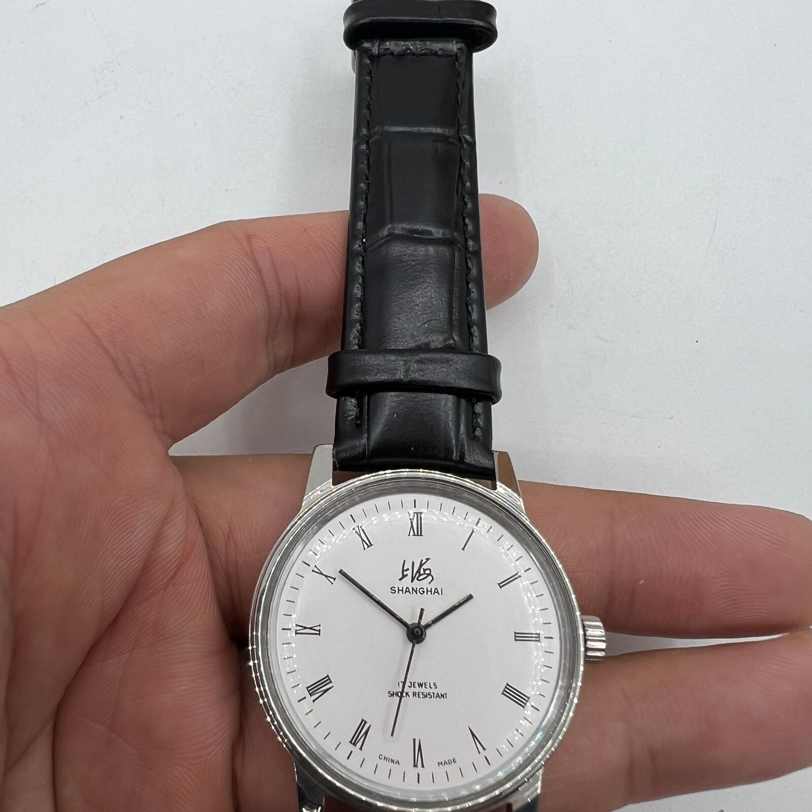 Vintage 36mm Shanghai Factory 8120 manual mechanical watch with 17-jewel shock-resistant movement, classic style.
