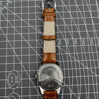 33mm Chunlan manual steel watch with silver dial, 17-jewel movement, and sleek black leather band.