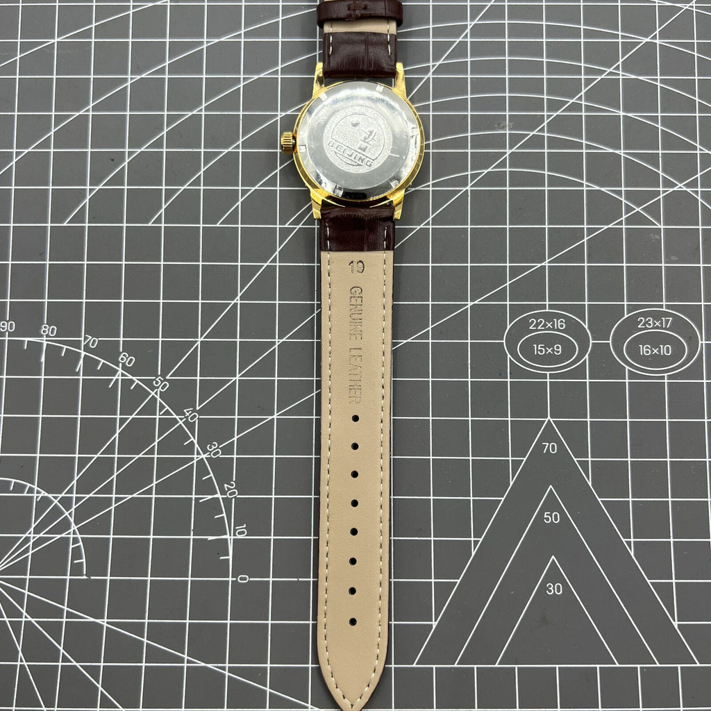 Beijing Double Rhomb mechanical watch with golden case and silver nail markers, elegant and classic style.