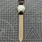 Beijing Double Rhomb mechanical watch with golden case and silver nail markers, elegant and classic style.