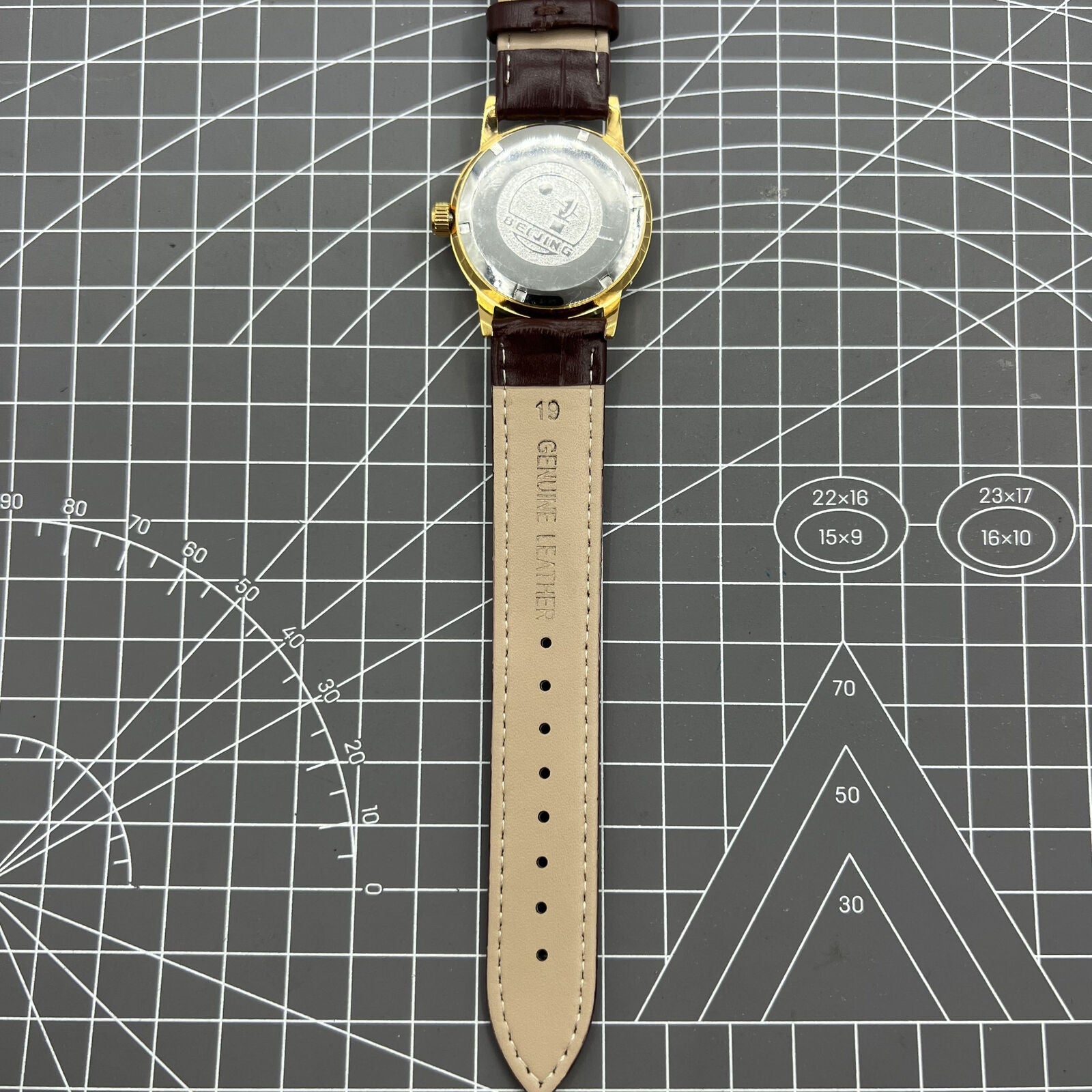 Beijing Double Rhomb mechanical watch with golden case and silver nail markers, elegant and classic style.