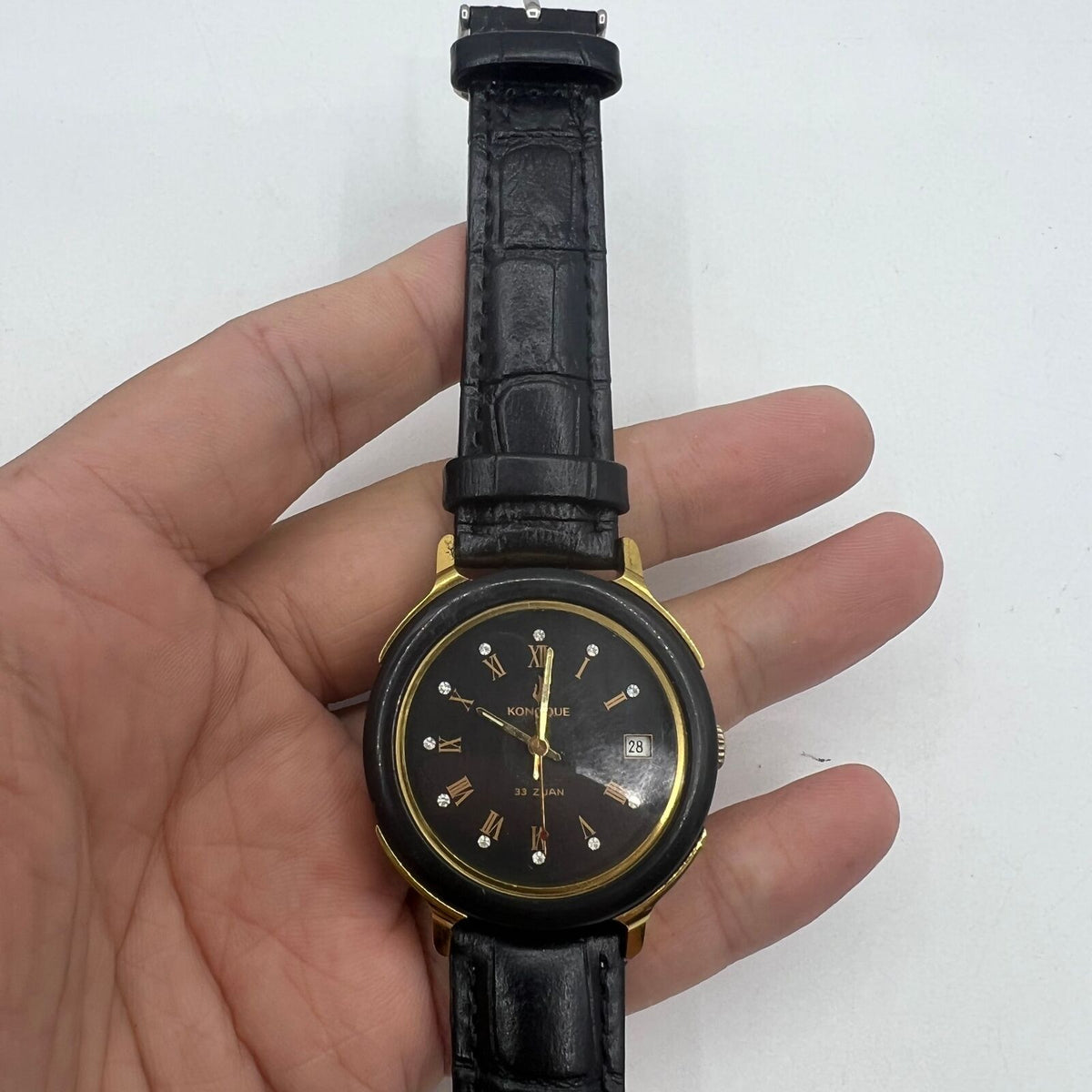 37mm automatic mechanical watch with black dial, golden Roman numerals, and 33 jewels.
