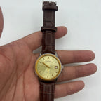 Shanghai 37mm manual watch with golden dial, nail markers, and round case, featuring 17 jewel mechanical movement.
