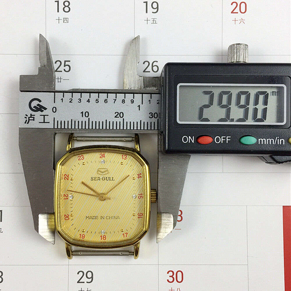 28mm Tianjin Seagull watch with octagonal gold case, golden dial, and manual mechanical movement.