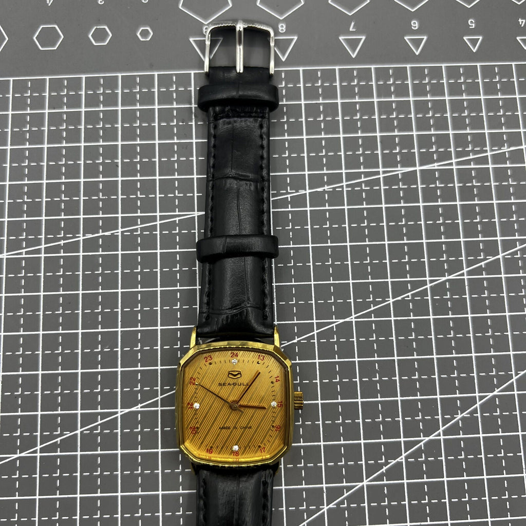 28mm Tianjin Seagull watch with octagonal gold case and golden dial, manual mechanical movement.