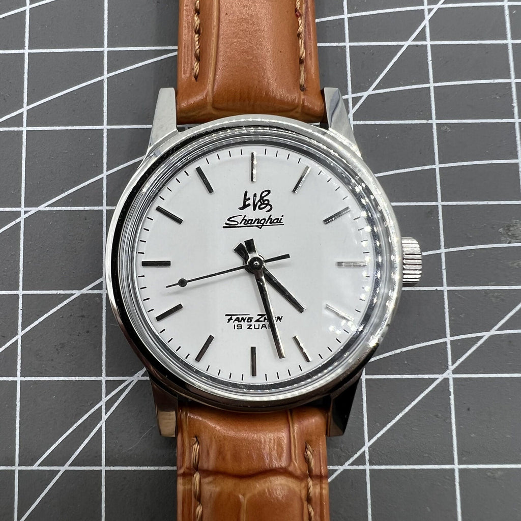 Shanghai Factory 32mm manual mechanical watch with 19 jewels, shock-resistant, classic design for everyday wear.