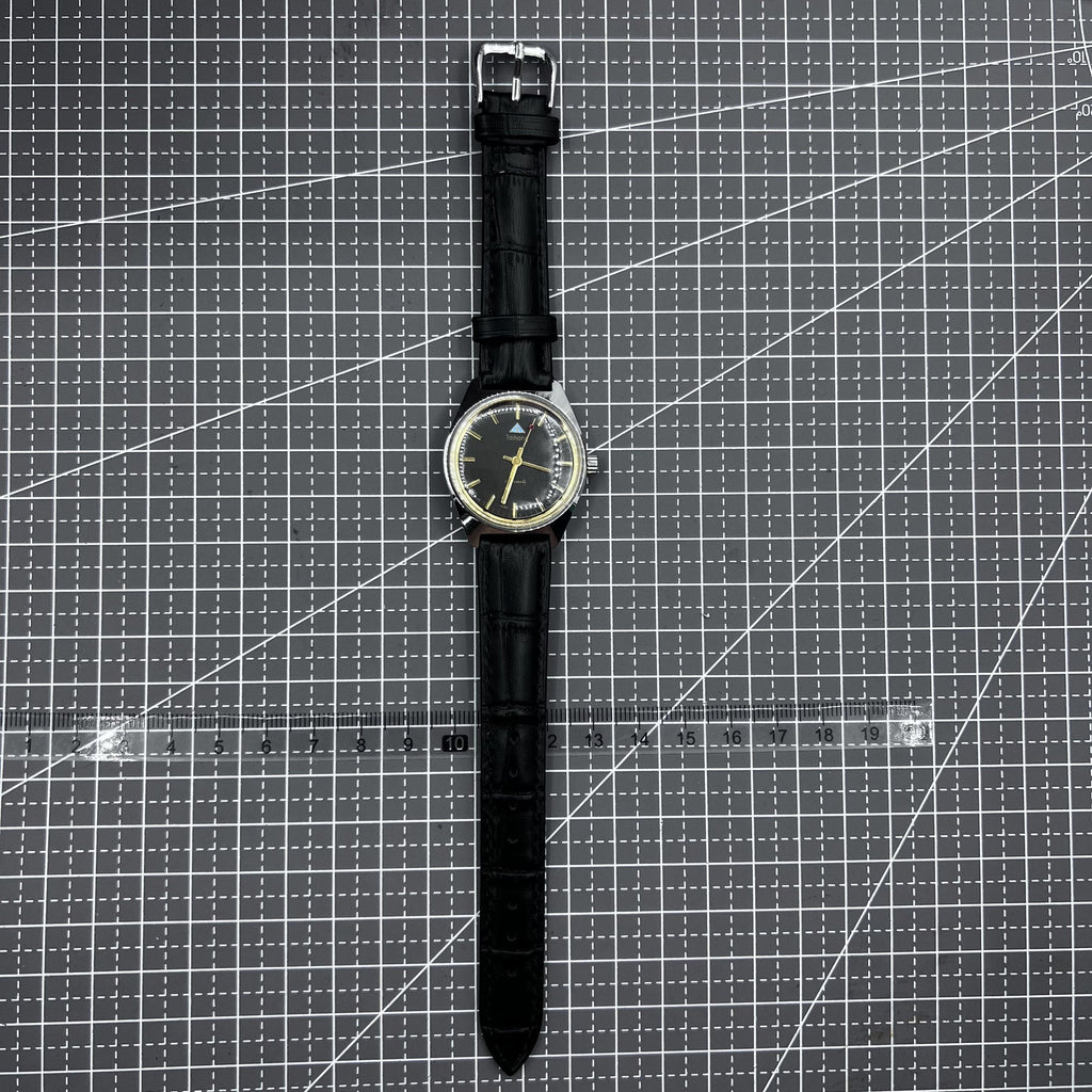 Taihang 32mm manual mechanical watch with black strap, golden nails, and black dial for classic style.