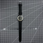Taihang 32mm manual mechanical watch with black strap, golden nails, and black dial for classic style.