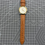 TAIHANG 38mm manual mechanical watch with silver dial, gold hour markers, round case, 17 jewels for precision.