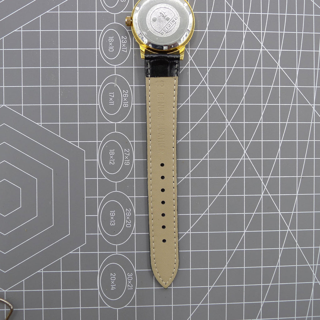 Beijing Double Rhomb mechanical watch in golden case with silver hour markers, elegant style for formal occasions.