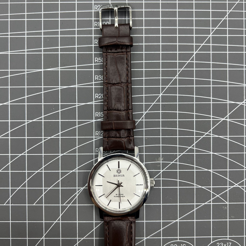 China Baihua 37mm manual mechanical watch with silver dial, 19 jewels, and shock-resistant design.