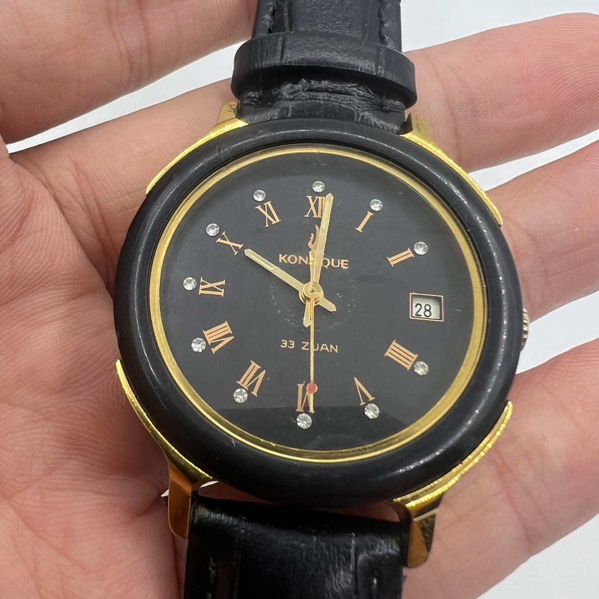 37mm automatic watch with black dial, golden Roman numerals, 33 jewels for elegant style.