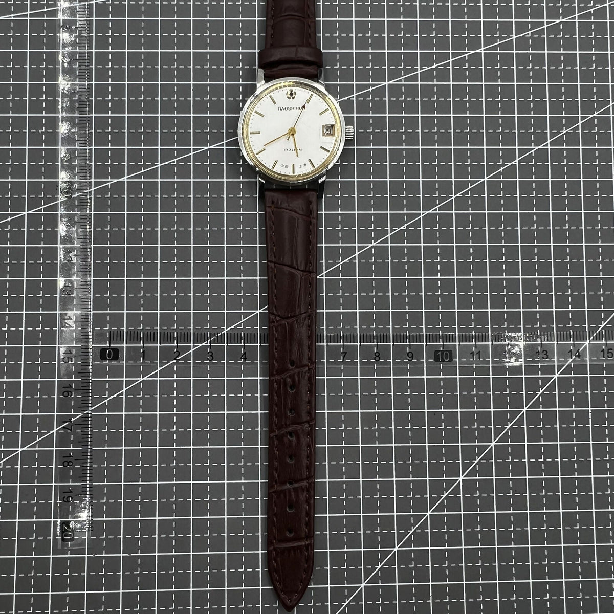 Shanghai 33mm manual mechanical watch with single calendar, 17 jewels, shock-resistant design for daily wear.