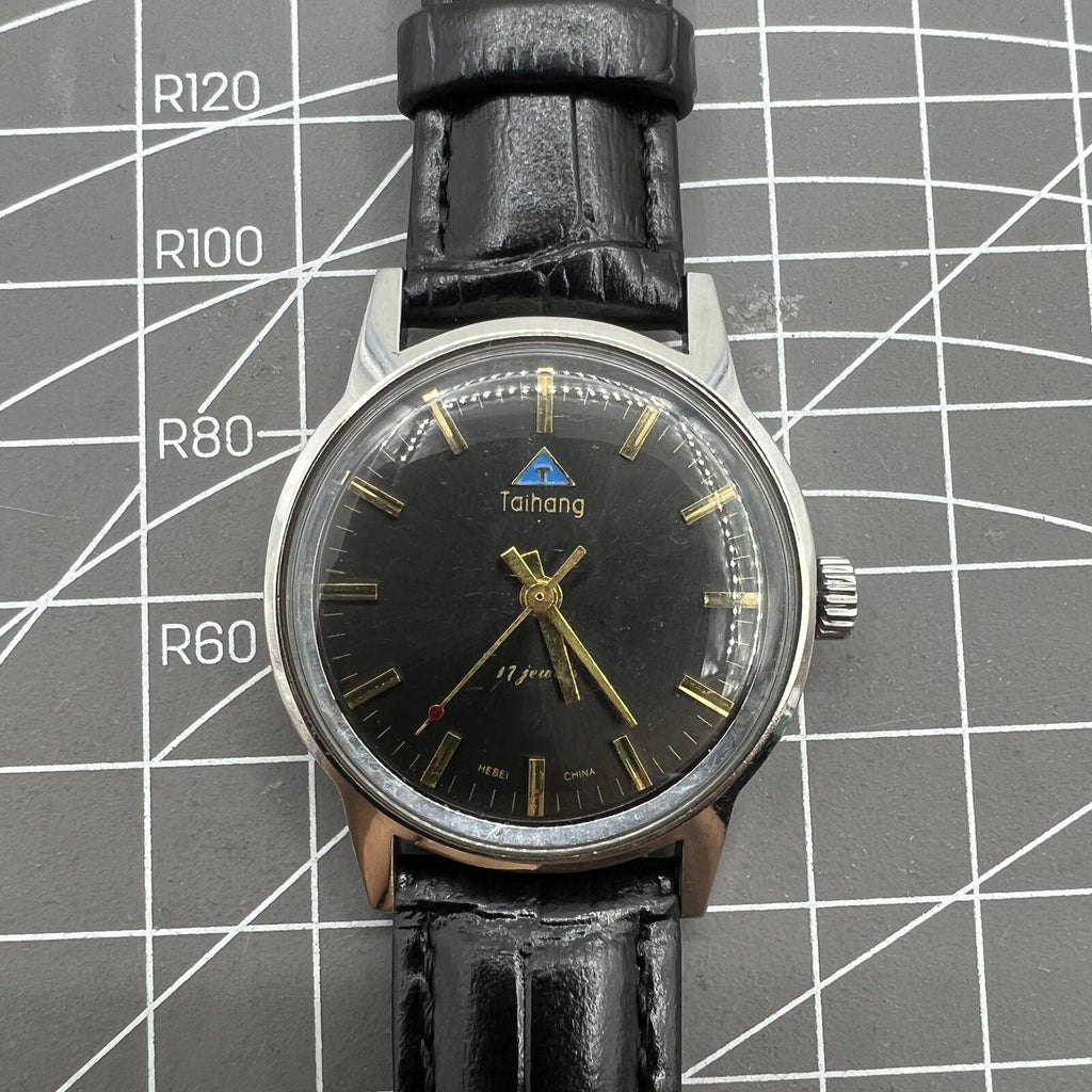 Taihang 32mm manual watch with black dial, golden markers, 17 jewels precision craftsmanship.