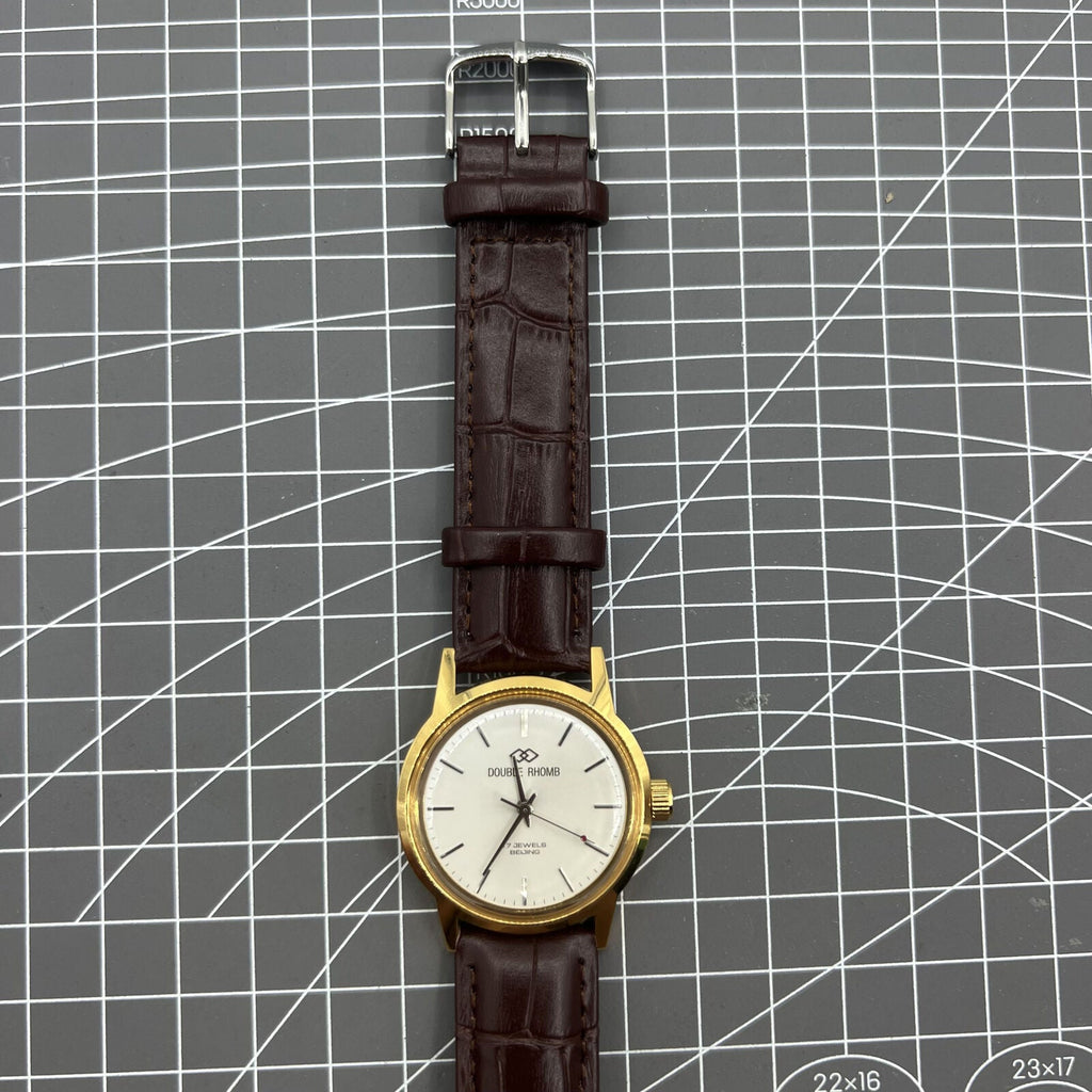 Beijing Double Rhomb mechanical watch with golden case and silver nail markers, elegant design