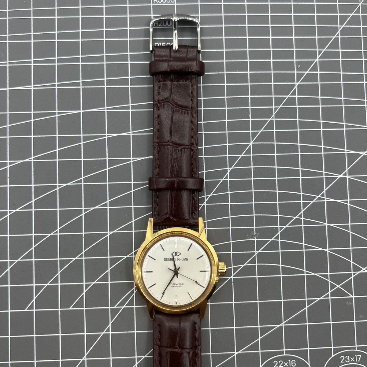 Beijing Double Rhomb mechanical watch with golden case and silver nail markers, elegant design