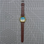33mm Shanghai watch with blue dial, golden nail markers, square case, manual mechanical movement, 17 jewels.