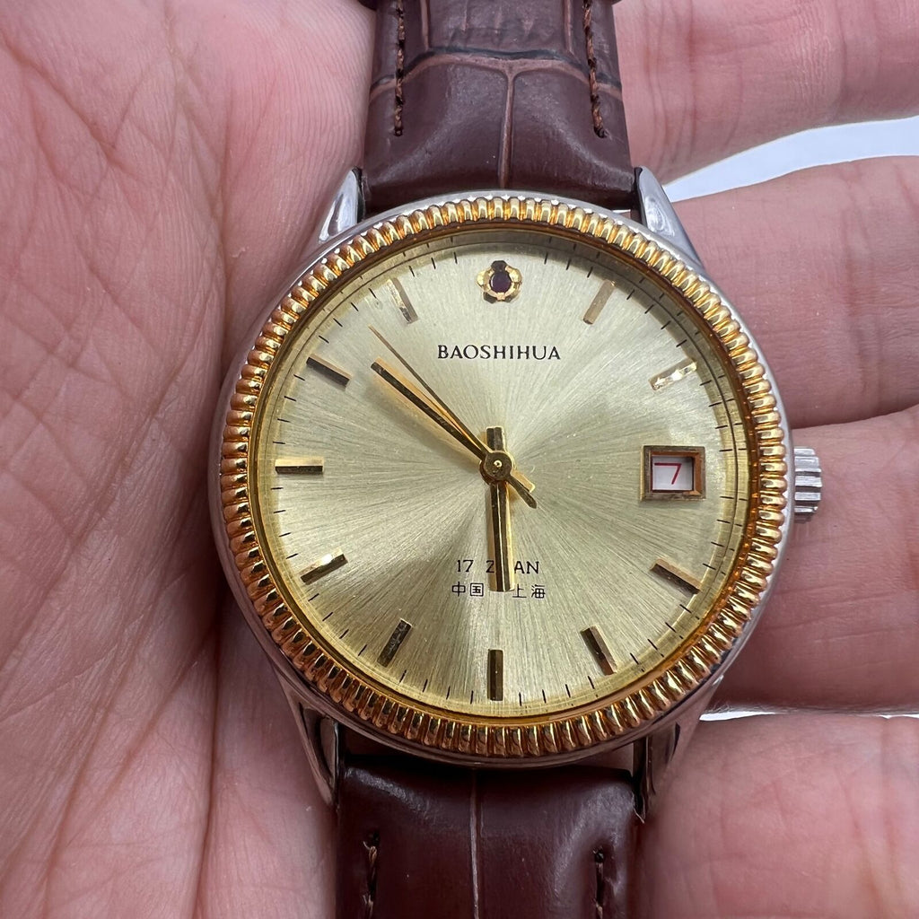 Shanghai 37mm manual watch with golden dial, nail markers, round case, 17 jewel mechanical movement by Shanghai brand.