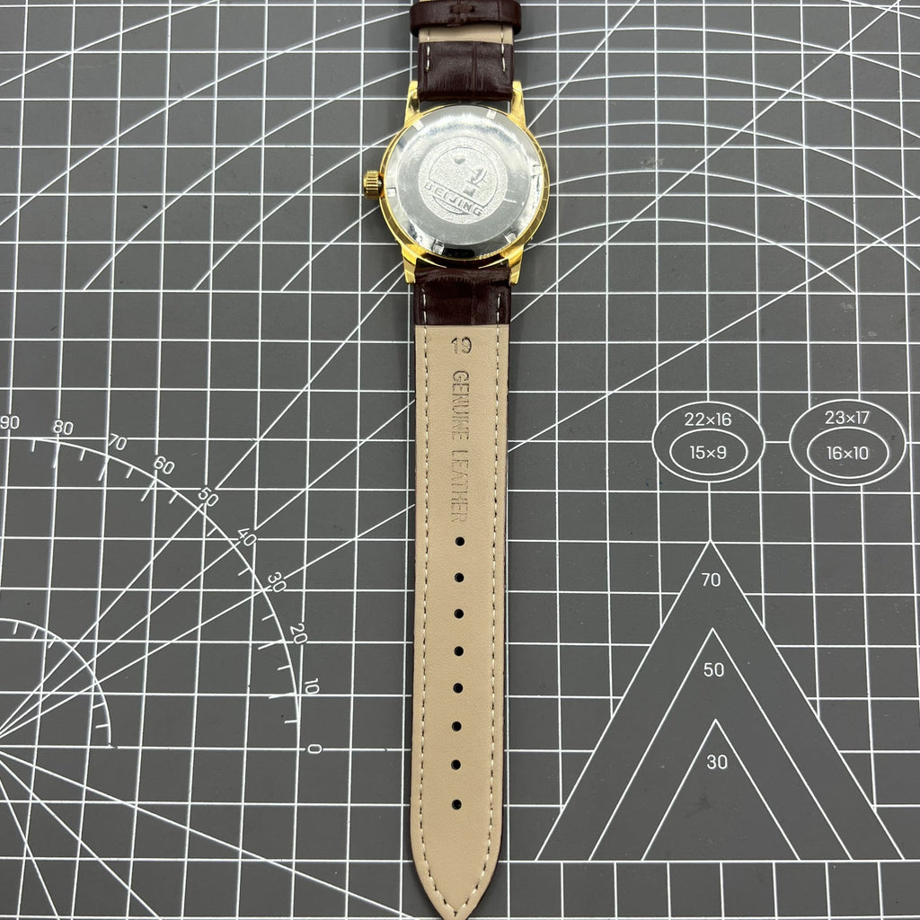 Beijing Double Rhomb manual watch with golden case, silver nail markers, classic style for elegant wear