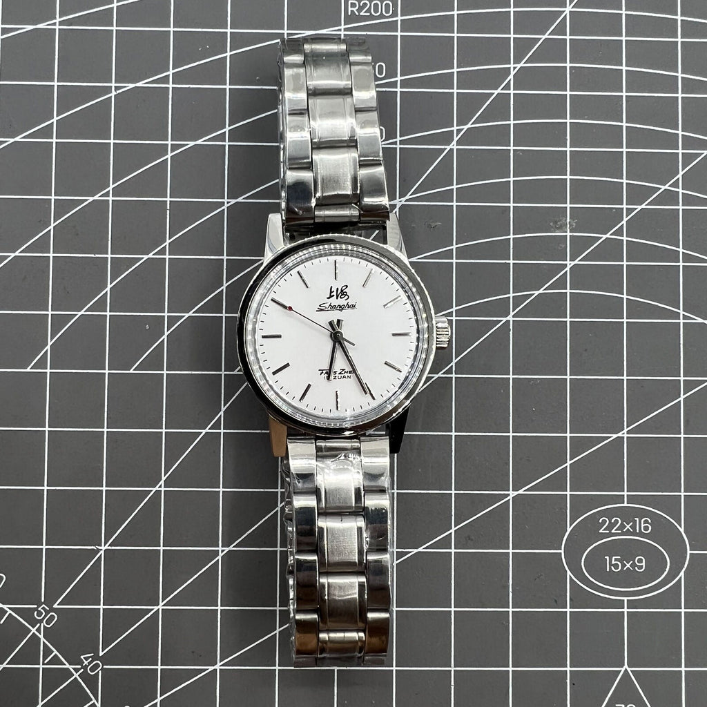 Silver 32mm Shanghai Factory manual mechanical watch with 19 jewels, shock-resistant, classic style.