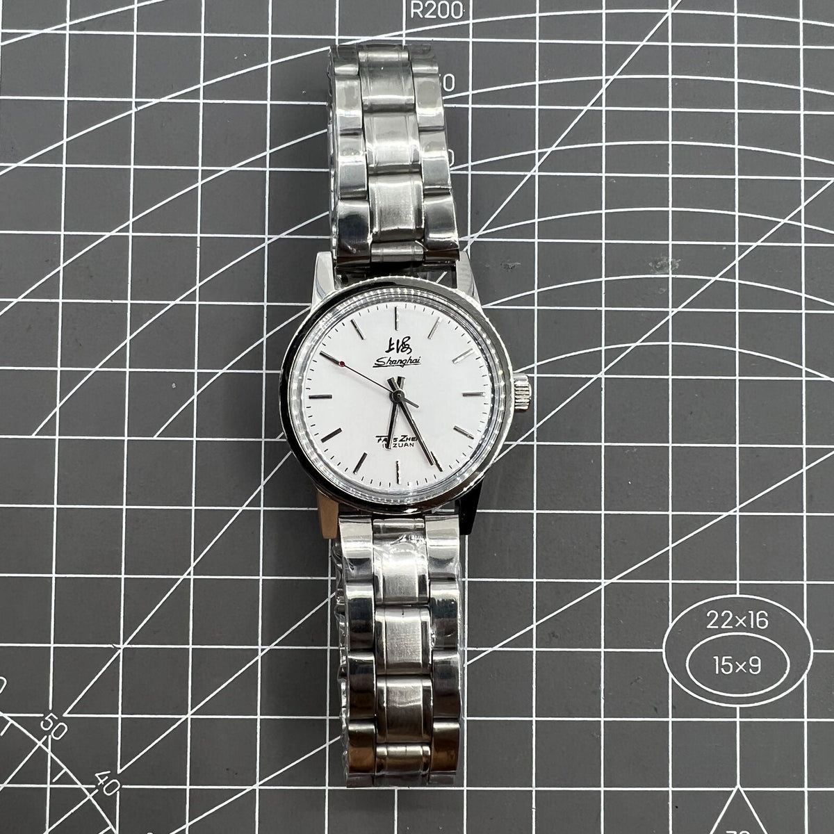 Silver 32mm Shanghai Factory manual mechanical watch with 19 jewels, shock-resistant, classic style.