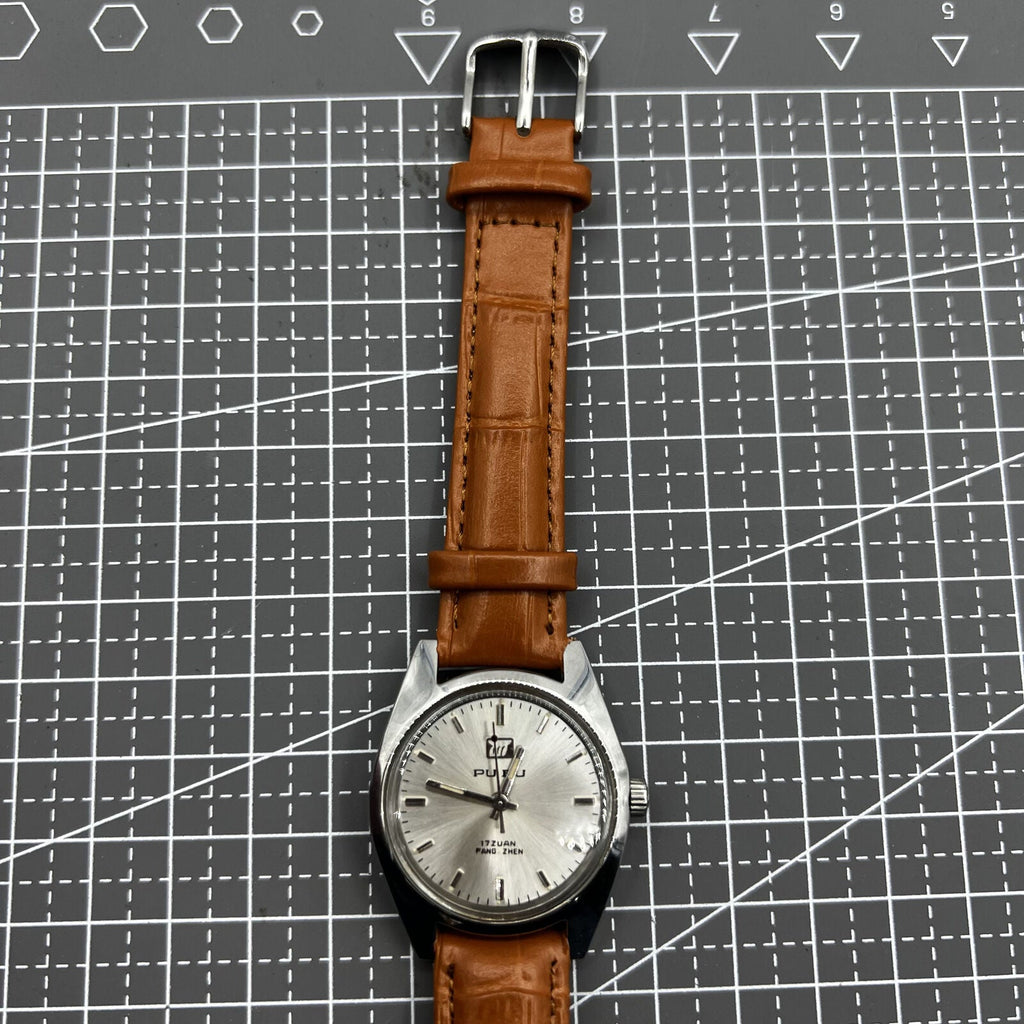 PUBU 32mm manual mechanical watch with grey dial and nail markers, 17 jewels, precision craftsmanship.