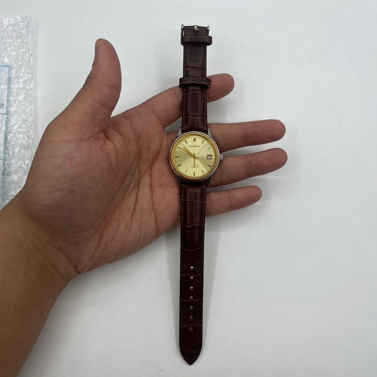 37mm Shanghai manual mechanical watch with golden dial and nails, round case, 17 jewels for precise timekeeping.