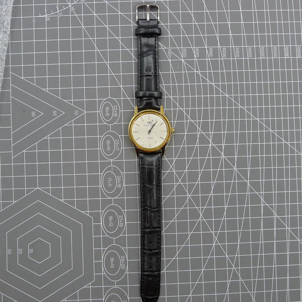 Beijing Double Rhomb mechanical watch with golden case and silver hour markers, elegant design.